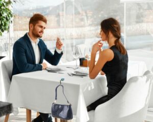 Handbag Holder Hanging On A Table At A Restaurant where a couple is enjoying a meal