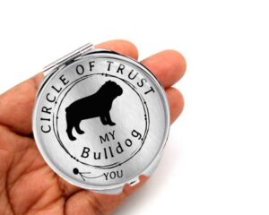 Circle of Trust compact mirror, laying on a woman's hand to show the size.