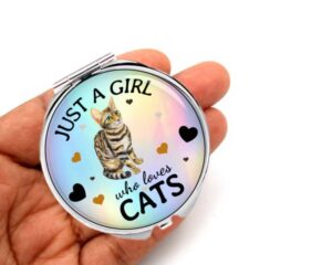 just a girl who loves pitbulls compact mirror, laying on a woman's hand to show the size.
