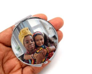 custom photo cosmetic compact mirror, laying on a woman's hand to show the size.