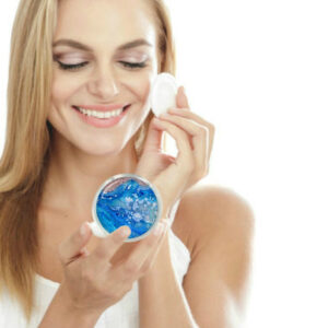 Compact mirror travel gift being used by a woman applying makeup. Created by Terlis Designs.