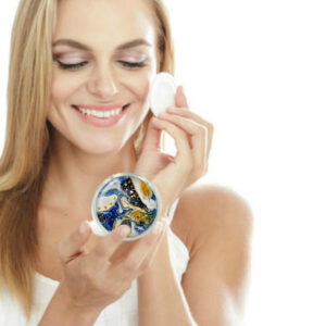 Cosmetic pocket mirror being used by a woman applying makeup. Created by Terlis Designs.