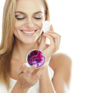 Custom Metal handheld mirror being used by a woman applying makeup. Created by Terlis Designs.