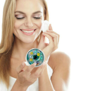 Custom floral handheld mirror being used by a woman applying makeup. Created by Terlis Designs.