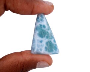 genuine larimar cab, held between the finger tips to give you an idea of its true size. By Terlis Designs