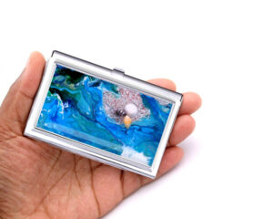 Ocean Art Credit Card Case Gift Bus60, Laying On A woman's Hand To Show The Size. Designed By Terlis Designs.