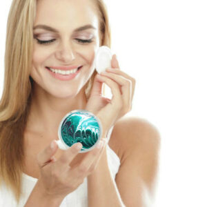 Seafoam green handheld mirror being used by a woman applying makeup. Created by Terlis Designs.