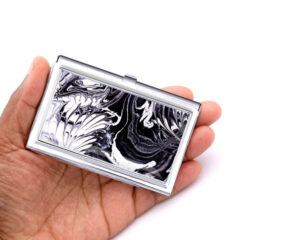 Silver Business Card Holder Bus129, Laying On A woman's Hand To Show The Size. Designed By Terlis Designs.