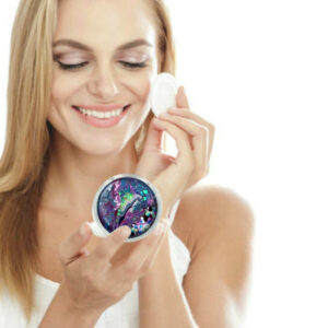 Small compact mirror being used by a woman applying makeup. Created by Terlis Designs.
