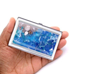 Stainless Steel Business Card Holder Bus7, Laying On A woman's Hand To Show The Size. Designed By Terlis Designs.