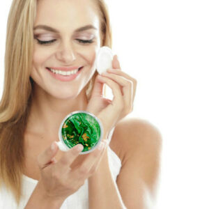 Travel compact mirror being used by a woman applying makeup. Created by Terlis Designs.
