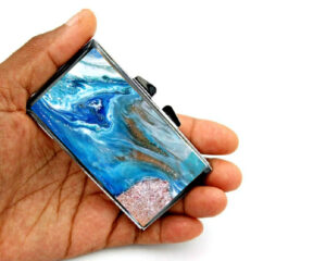 7 day Pill Case - PILB139, laying on a woman's hand to show the size, image by Terlis Designs.