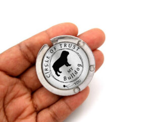 Circle of trust purse hanger for table, item sku PURH446, laying on a woman's hand to show the size image by Terlis Designs.