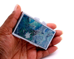 Ocean art Medicine Pill Holder - PILB68, laying on a woman's hand to show the size, image by Terlis Designs.