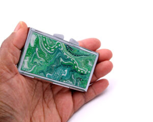 Small Pill Case - PILB163, laying on a woman's hand to show the size, image by Terlis Designs.
