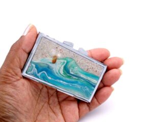Travel Pill Holder - PILB70, laying on a woman's hand to show the size, image by Terlis Designs.