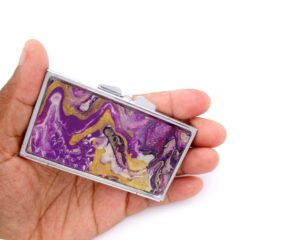 Travel Pill Organizer - PILB27, laying on a woman's hand to show the size, image by Terlis Designs.