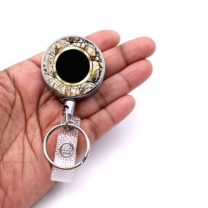 Animal Print retractable badge reel - BADR447B - laying on a woman's hand to show the size. Designed By Terlis Designs.