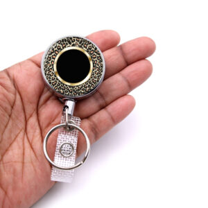 Animal Skin Print medical badge reel - BADR448B - laying on a woman's hand to show the size. Designed By Terlis Designs.