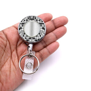 Black Silver Animal Print teacher badge reel - BADR453B - laying on a woman's hand to show the size. Designed By Terlis Designs.