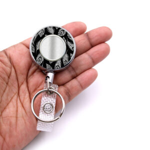 Black Silver Glitter employee badge reel - BADR454B - laying on a woman's hand to show the size. Designed By Terlis Designs.