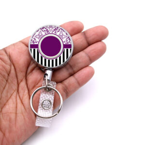 Black Striped retractable badge reel - BADR471B - laying on a woman's hand to show the size. Designed By Terlis Designs.