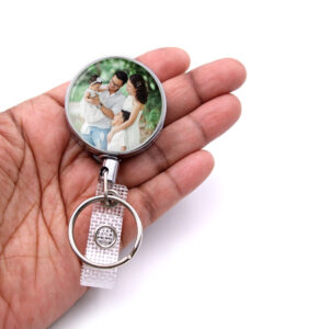Custom Photo retractable badge reel - BADR481 - laying on a woman's hand to show the size. Designed By Terlis Designs.