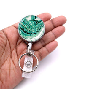 Employee badge reel - BADR379 - laying on a woman's hand to show the size. Designed By Terlis Designs.