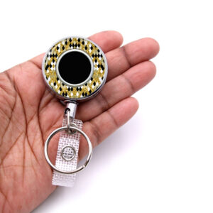 Gold Glitter Animal Print badge reel - BADR450B - laying on a woman's hand to show the size. Designed By Terlis Designs.