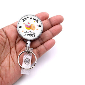 Just A Girl Who Loves Donuts badge reel - BADR424 - laying on a woman's hand to show the size. Designed By Terlis Designs.