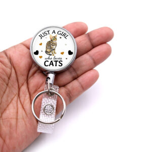 Just A Girl Who Loves Pitbulls badge reel - BADR422 - laying on a woman's hand to show the size. Designed By Terlis Designs.