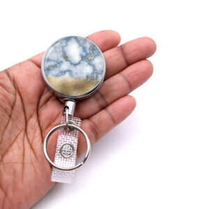 Marble badge reel - BADR427 - laying on a woman's hand to show the size. Designed By Terlis Designs.