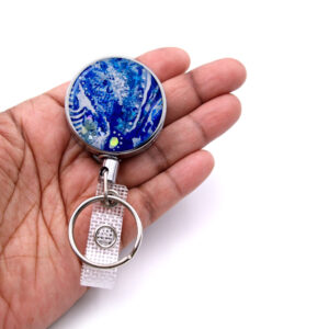 Medical badge reel - BADR100 - laying on a woman's hand to show the size. Designed By Terlis Designs.