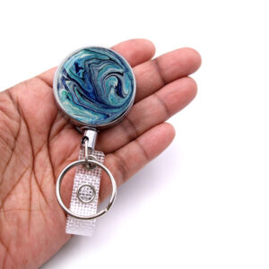 Medical key holder - BADR102 - laying on a woman's hand to show the size. Designed By Terlis Designs.