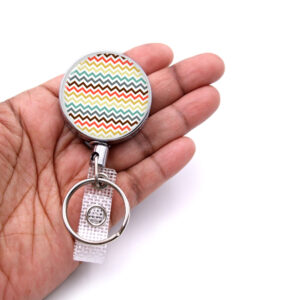Monogram Initial retractable badge reel personalized - BADR441 - laying on a woman's hand to show the size. Designed By Terlis Designs.