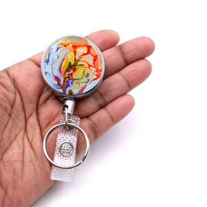 Personalized key holder - BADR37 - laying on a woman's hand to show the size. Designed By Terlis Designs.