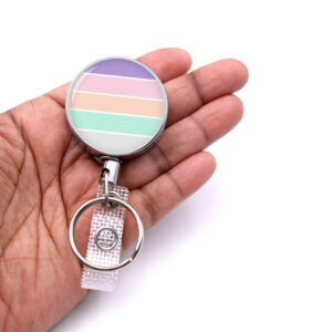 Personalized retractable badge reel - BADR438 - laying on a woman's hand to show the size. Designed By Terlis Designs.