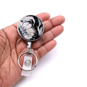Registered nurse key holder - BADR145 - laying on a woman's hand to show the size. Designed By Terlis Designs.