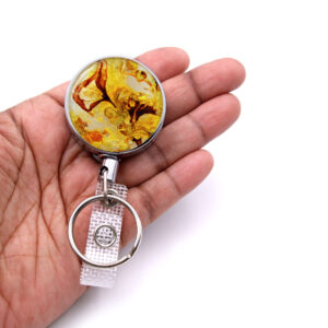 Retractable name tag holder - BADR335 - laying on a woman's hand to show the size. Designed By Terlis Designs.