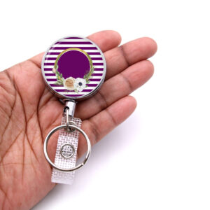 Striped Print RN badge reel - BADR473B - laying on a woman's hand to show the size. Designed By Terlis Designs.