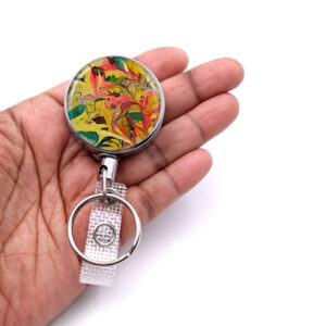 Teacher key holder - BADR73 - laying on a woman's hand to show the size. Designed By Terlis Designs.
