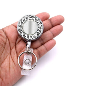 White Silver Animal Print Id badge reel - BADR455B - laying on a woman's hand to show the size. Designed By Terlis Designs.