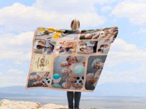 Custom Anniversary Collage Photo Blanket - BLANAI1, showing a lady camping outdoors wearing the plush blanket over her shoulders.