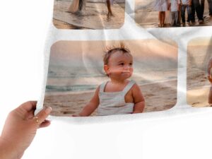 Custom Picture Collage Blanket With Text - BLANABM1, closeup view of the blanket held between the thumbs and fingers.