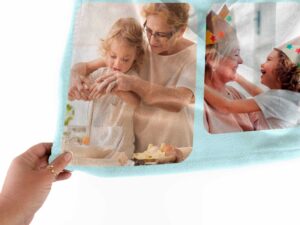 Customizable Photo Collage Blanket - BLANZM1, closeup view of the blanket held between the thumbs and fingers.
