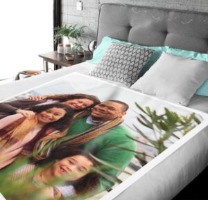 Family Photo Collage Personalized Memorial Blanket - BLANA1, laid over a queen sized bed to show the plush blanket in use.