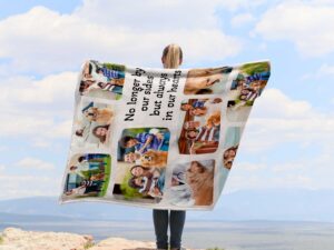 Pet Loss Photo Collage Memorial Blanket - BLANAB1, showing a lady camping outdoors wearing the plush blanket over her shoulders.